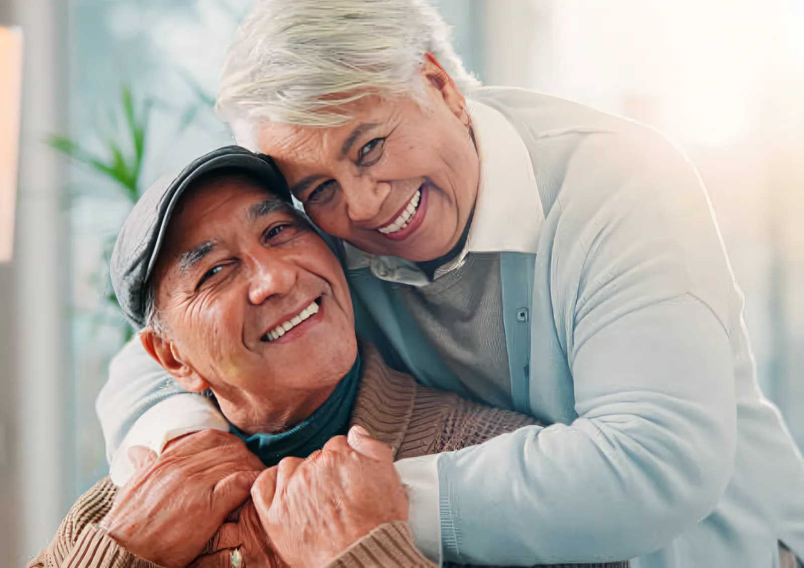 An older couple embracing and laughing together